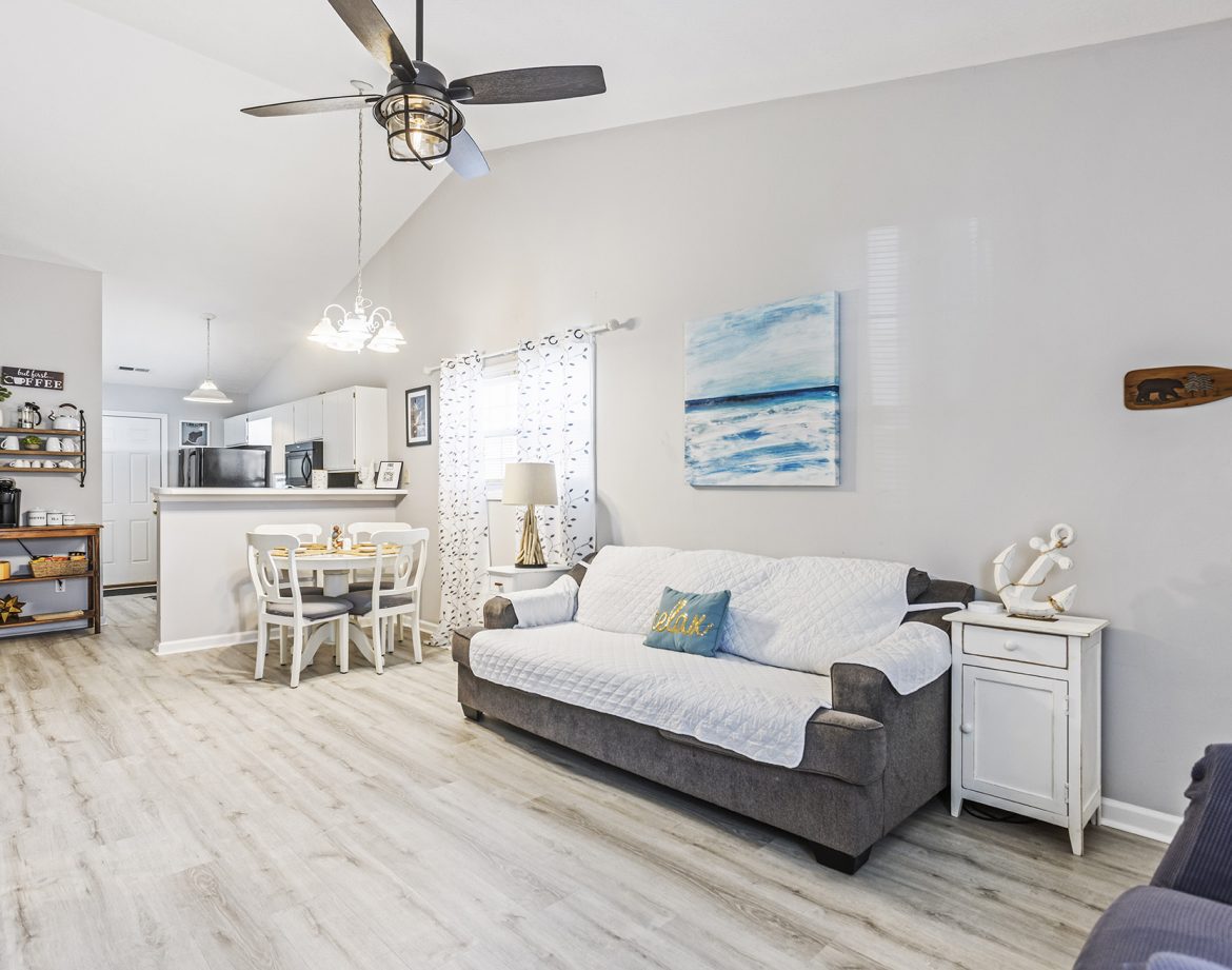Children playing in the fenced yard with their dog.